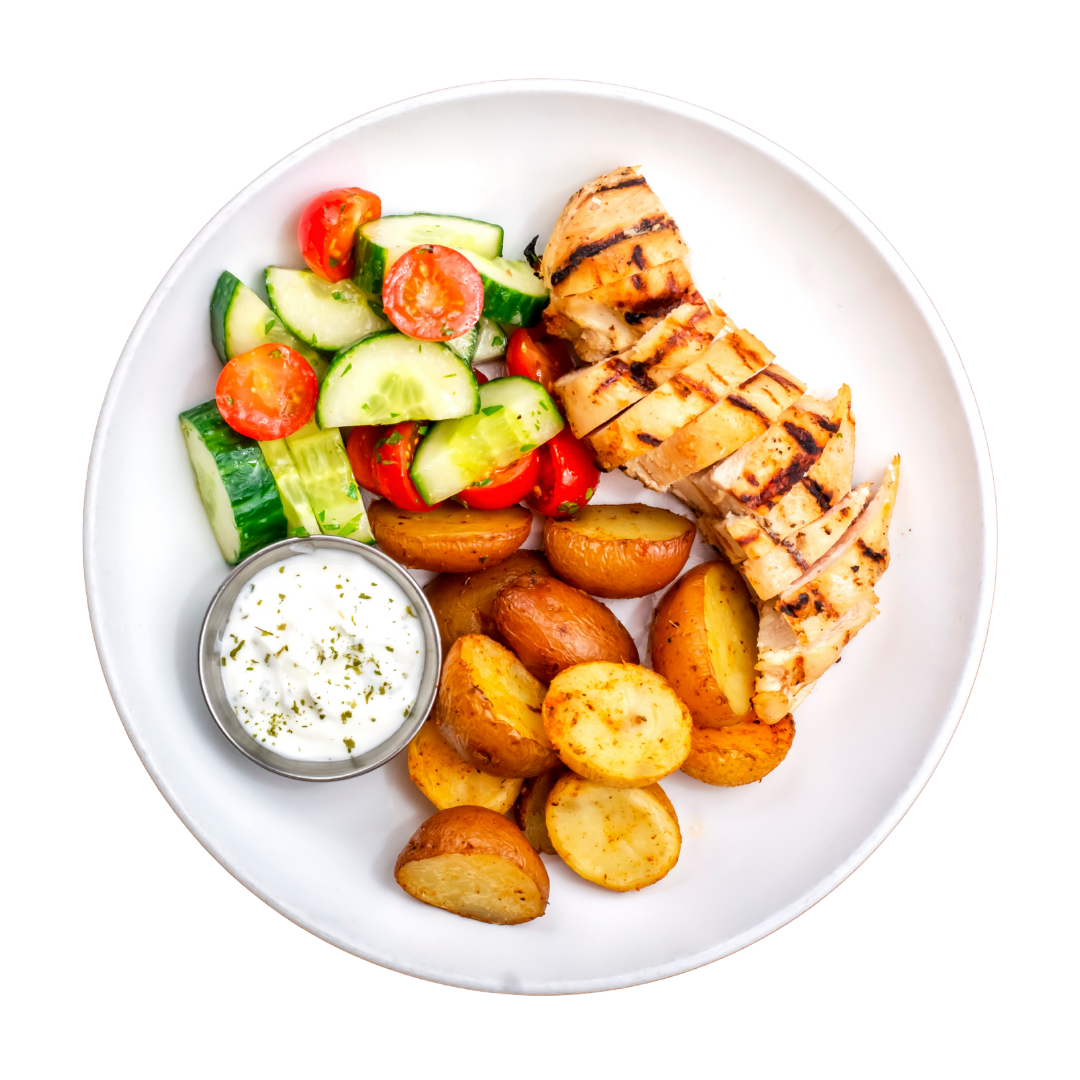 Chicken Souvlaki dish with grilled chicken, potatoes, and a side salad on a white background